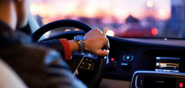 man driving a car wearing wrist watch